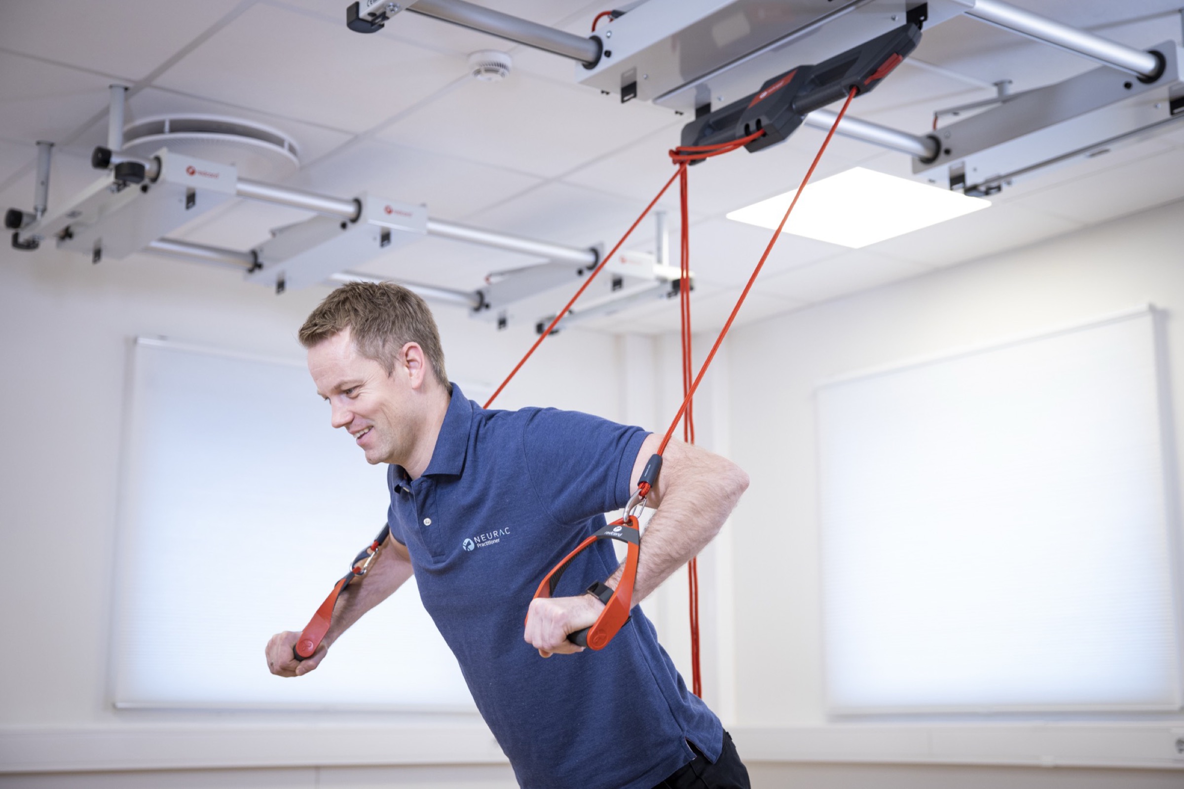Practitioner adapting Redcord exercises to a client's functional level